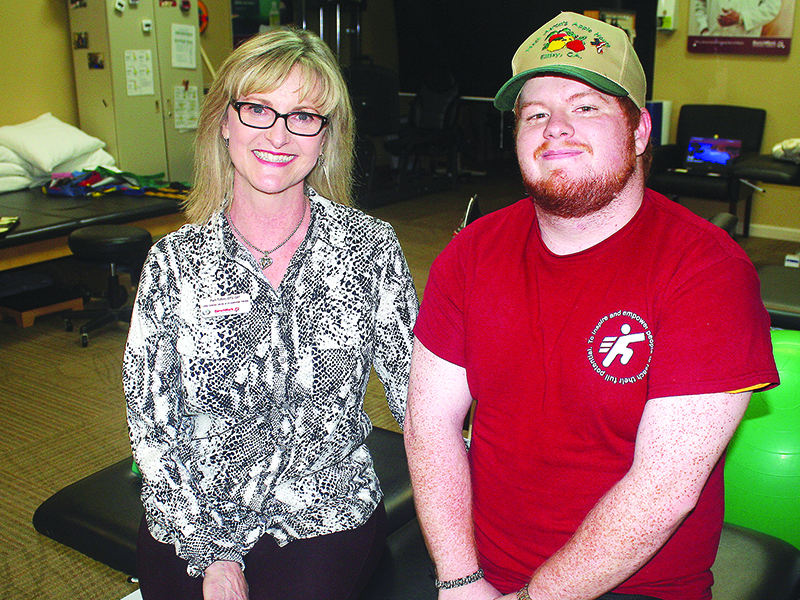 Pam Tutten, of BenchMark Physical Therapy, left, catches up with Christopher Adams during a recent therapy session at the East Ellijay clinic.