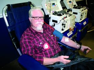 Ernie Russell waits patiently while donating double red blood cells at the last Northeast Georgia Red Cross blood drive to be held at the Ellijay Lions Club this decade.